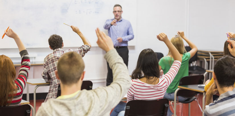 Students raised hands to answer questions in an english language class