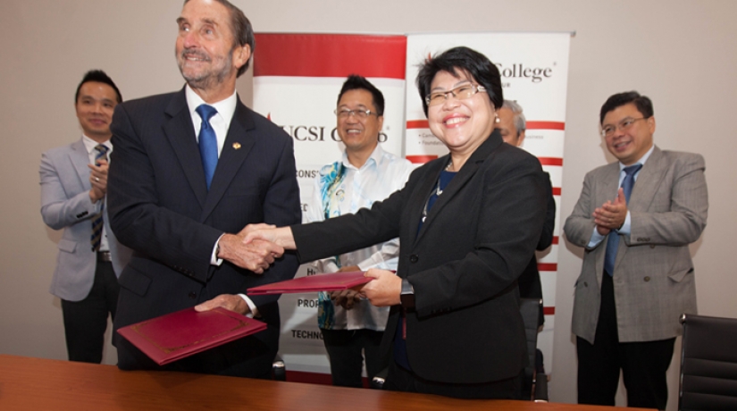 Dr Mabel and Betz exchange mementos after the MoU signing ceremony